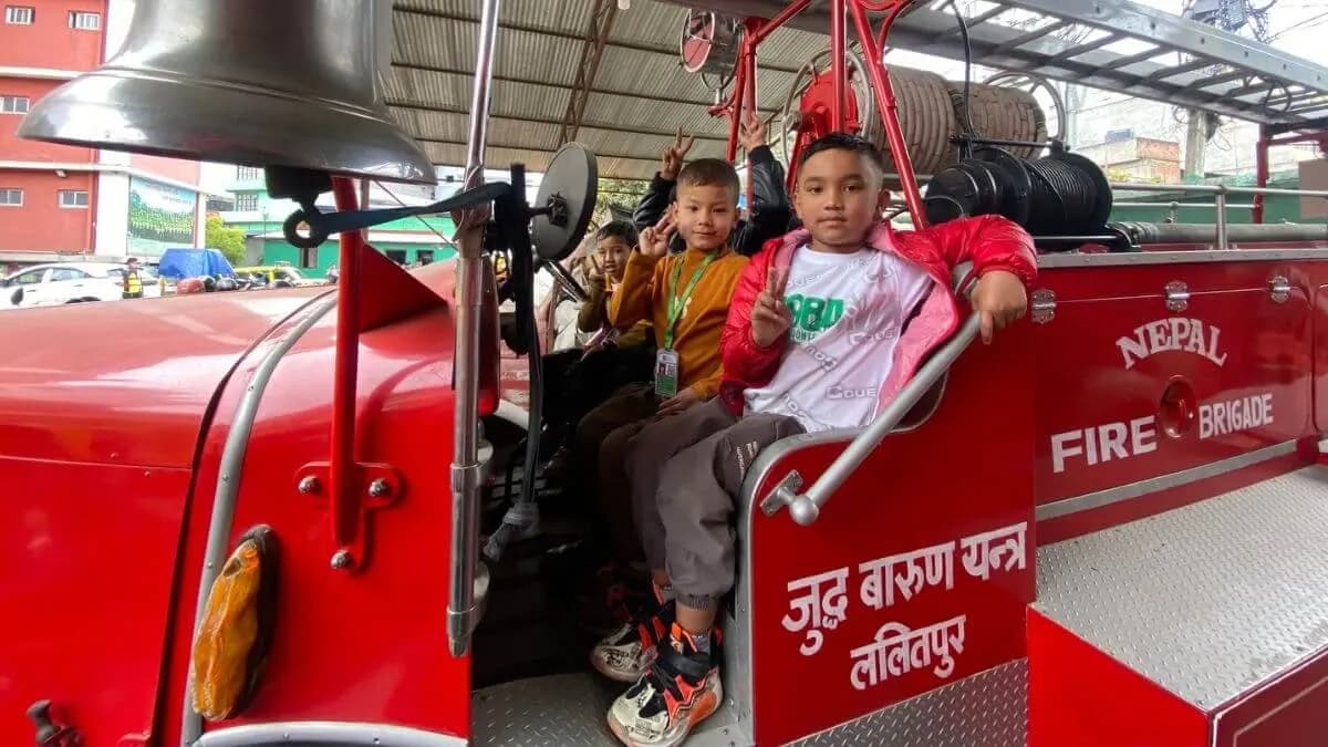 Children in the cab of a fire engine