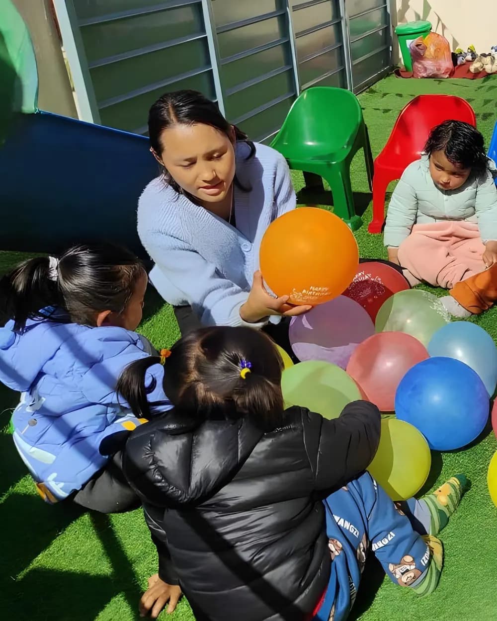 A teacher playing with toddlers
