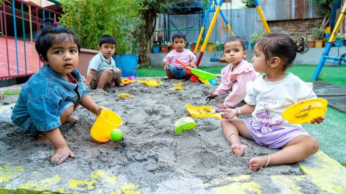 Children digging in the sand pit
