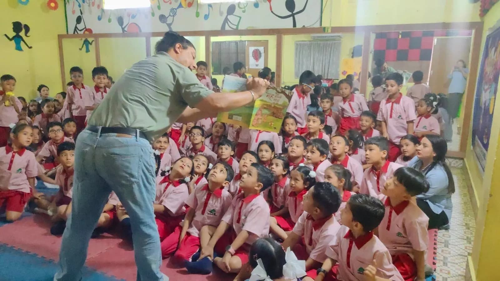 A teacher holding up a picture book